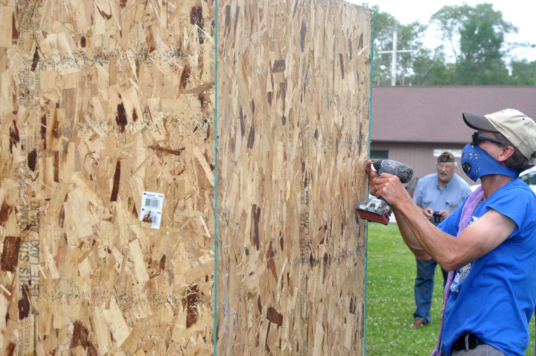 David Speedling, co-owner of SVJ Creative Designs, drills a hole in a large, wooden box
